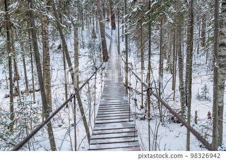 Beautiful rope hanging wooden bridge. winter landscape 98326942