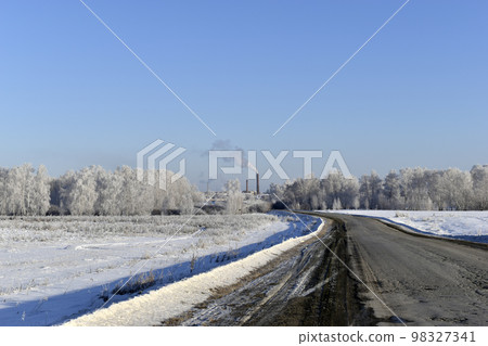 A high-speed road in a snow-covered field. Snowy road in winter. A high-speed road in a snow-covered field. Snowy road in winter. 98327341