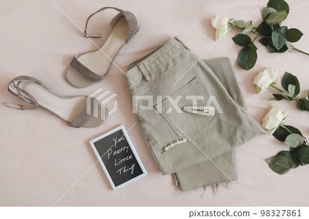 Women jeans, shoes and flowers top view. Women's stylish spring summer outfit. Trendy clothes. Flat lay Women jeans, shoes and flowers top view. Women's stylish spring summer outfit. Trendy clothes. Flat lay 98327861