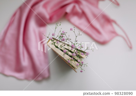 Flat lay composition with elegant pink dress, book, flowers on white background top view Flat lay composition with elegant pink dress, book, flowers on white background top view 98328090