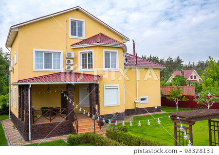 A perfect nighborhood. Average residential house with concrete pathway to the main entrance over lush front yard lawn A perfect nighborhood. Average residential house with concrete pathway to the main entrance over lush front yard lawn 98328131