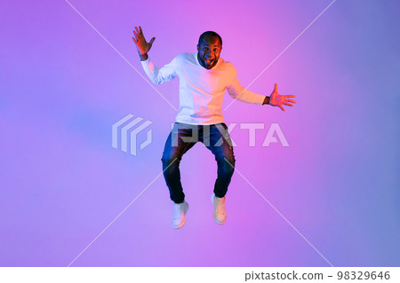 Thrilled emotional black man showing excitement on studio background 98329646