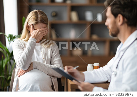 Portrait Of Crying Pregnant Woman During Meeting With Gynecologist Doctor Portrait Of Crying Pregnant Woman During Meeting With Gynecologist Doctor 98329672