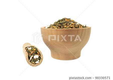 Green tea Japanese Genmaicha. Green tea mixed with roasted popped brown rice in wooden bowl and scoop isolated on white background. Green tea Japanese Genmaicha. Green tea mixed with roasted popped brown rice in wooden bowl and scoop isolated on white background. 98330571