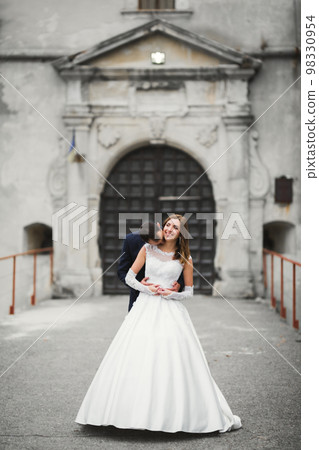 Romantic wedding moment, couple of newlyweds smiling portrait, bride and groom hugging 98330954