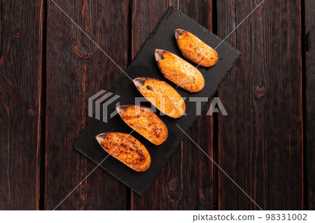 Baked mussels with cheese sesame seeds in shells - asian food Baked mussels with cheese sesame seeds in shells - asian food 98331002