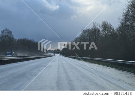 Wet highway against a dramatic sky on a stormy day 98331438
