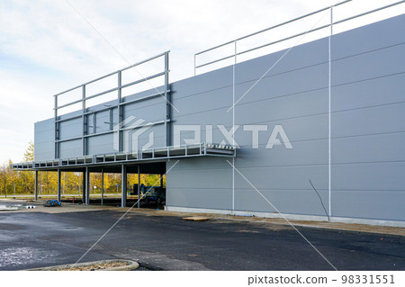 Unfinished metal frame warehouse building facade covered with thermally insulated sandwich panels Unfinished metal frame warehouse building facade covered with thermally insulated sandwich panels 98331551