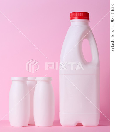 White plastic bottle for milk and dairy products on a pink background 98331638