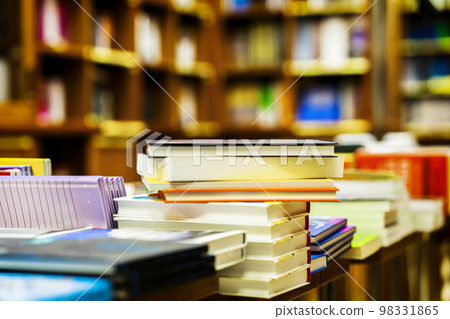 Blurred bookstore with books on tables and shelves. Education, school, study, reading fiction concept Blurred bookstore with books on tables and shelves. Education, school, study, reading fiction concept 98331865