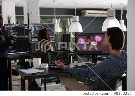 Asian app developer having web server hacked, dealing with critical error on computer display in it big data office. System engineer trying to solve hacking problem, firewall security. 98333235