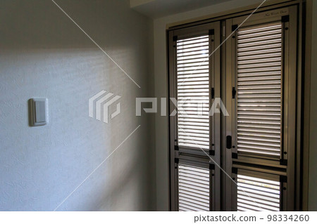 The screen door of the entrance where light shines The screen door of the entrance where light shines 98334260