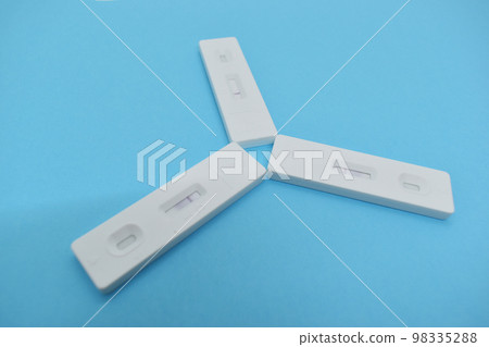 covid test kit on blue background 98335288