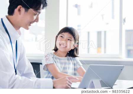 Girl and teacher learning on tablet 98335622