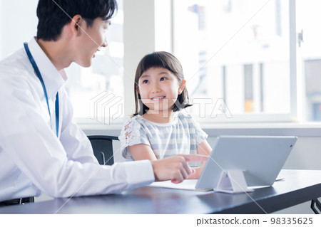 Girl and teacher learning on tablet 98335625