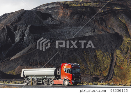 Truch driving from Volcanic red stone quarry in Iceland 98336135