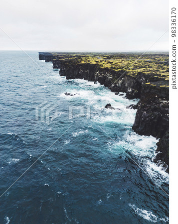 Vertical photo of black rocky volcanic west coast of Iceland Vertical photo of black rocky volcanic west coast of Iceland 98336170