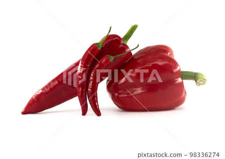 Fresh chili peppers and red bell peppers over white 98336274