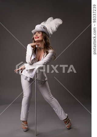 Woman in white suit with hat and cane 98337239