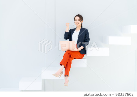 Business woman on the stairs Business woman on the stairs 98337602
