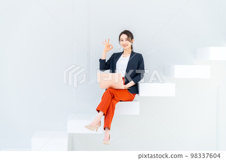 Business woman on the stairs Business woman on the stairs 98337604