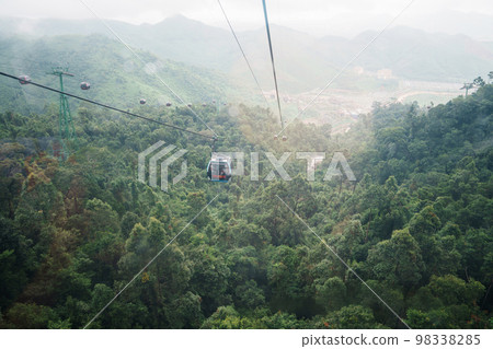 View of Ba Na Hills Mountain in the fog from Cable car. Landmark and popular. Da Nang, Vietnam and Southeast Asia travel concept 98338285