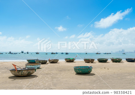 Basket boats at My Khe beach in Da Nang city, Vietnam. Local fishing boats of Danang have become iconic to Vietnam. Southeast Asia travel concept 98338421