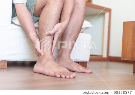 Man having leg pain due to Ankle Sprains or Achilles Tendonitis and Shin Splints ache. injuries, health and medical concept 98338577