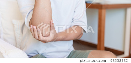 Man having elbow ache and muscle pain due to lateral epicondylitis or tennis elbow. injuries and medical concept Man having elbow ache and muscle pain due to lateral epicondylitis or tennis elbow. injuries and medical concept 98338582