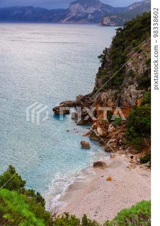 Sandy Beach on a rocky coast near Cala Gonone, Sardinia. Sandy Beach on a rocky coast near Cala Gonone, Sardinia. 98338602