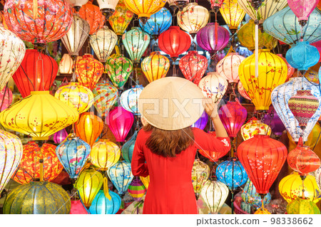 happy woman wearing Ao Dai Vietnamese dress with colorful lanterns, traveler sightseeing at Hoi An ancient town in central Vietnam.landmark for tourist attractions.Vietnam and Southeast travel concept happy woman wearing Ao Dai Vietnamese dress with colorful lanterns, traveler sightseeing at Hoi An ancient town in central Vietnam.landmark for tourist attractions.Vietnam and Southeast travel concept 98338662