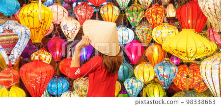 happy woman wearing Ao Dai Vietnamese dress with colorful lanterns, traveler sightseeing at Hoi An ancient town in central Vietnam.landmark for tourist attractions.Vietnam and Southeast travel concept happy woman wearing Ao Dai Vietnamese dress with colorful lanterns, traveler sightseeing at Hoi An ancient town in central Vietnam.landmark for tourist attractions.Vietnam and Southeast travel concept 98338663