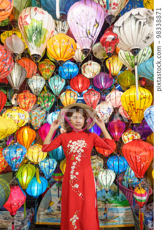 happy woman wearing Ao Dai Vietnamese dress with colorful lanterns, traveler sightseeing at Hoi An ancient town in central Vietnam.landmark for tourist attractions.Vietnam and Southeast travel concept happy woman wearing Ao Dai Vietnamese dress with colorful lanterns, traveler sightseeing at Hoi An ancient town in central Vietnam.landmark for tourist attractions.Vietnam and Southeast travel concept 98338871
