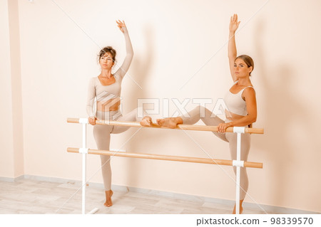 Well looking middle aged womans, fitness instructor in beige sportswear, preparing for stretching and pilates on yoga mat in the gym. Female fitness yoga concept. Healthy lifestyle harmony, meditation 98339570