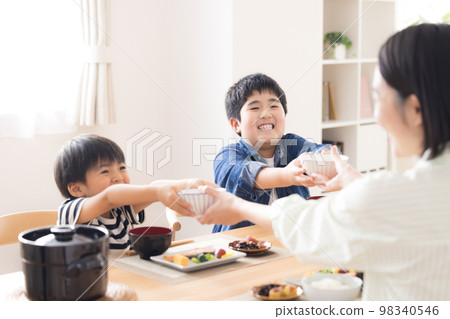 Family Meal Brothers refilling rice 98340546