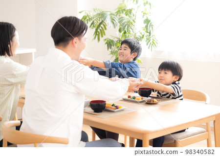 Family Meal Brothers refilling rice 98340582