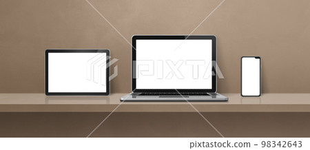 Laptop, mobile phone and digital tablet pc on brown wall shelf. Banner background Laptop, mobile phone and digital tablet pc on brown wall shelf. Banner background 98342643