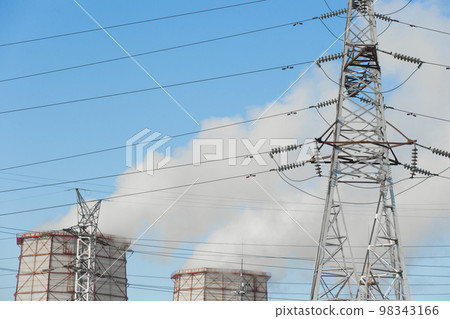 Smoke cooling tower pollution of the surrounding air environment of the atmosphere from the industrial plant and power lines high voltage tower Smoke cooling tower pollution of the surrounding air environment of the atmosphere from the industrial plant and power lines high voltage tower 98343166