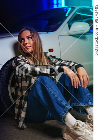 Young hipster girl near old sport car at night city 98343485