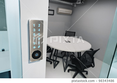 Electronic digital door lock on white office wall 98343486