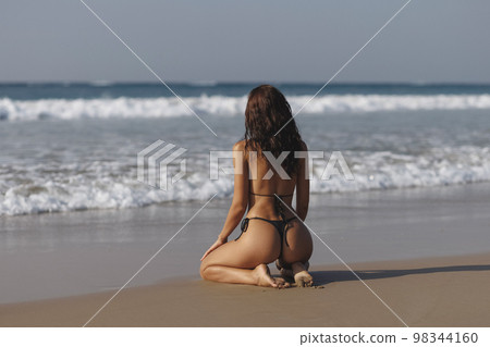 Fashion shot of a gorgeous young woman on the beach. Fashion shot of a gorgeous young woman on the beach. 98344160