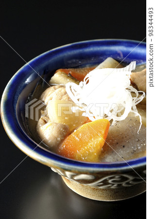 Stewed pork with carrots, konnyaku, burdock and radish on a black background Stewed pork with carrots, konnyaku, burdock and radish on a black background 98344493