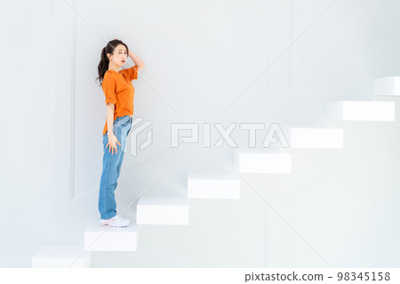 young woman on stairs 98345158