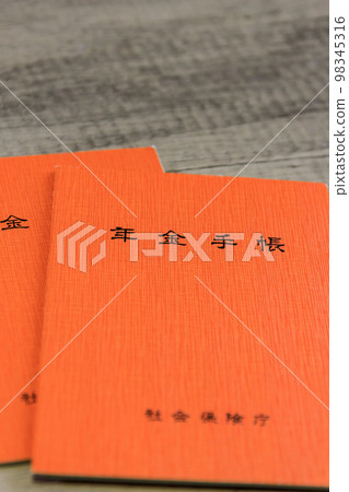 Pension book and 100 yen coin Pension book and 100 yen coin 98345316