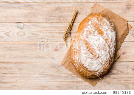 Freshly baked delicious french bread with napkin on rustic table top view. Healthy white bread loaf Freshly baked delicious french bread with napkin on rustic table top view. Healthy white bread loaf 98345388