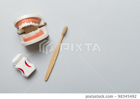 Closeup model of a human jaw with white teeth and Toothbrush. Dentistry conceptual photo. Prosthetic dentistry. False teet top view with copy space Closeup model of a human jaw with white teeth and Toothbrush. Dentistry conceptual photo. Prosthetic dentistry. False teet top view with copy space 98345492