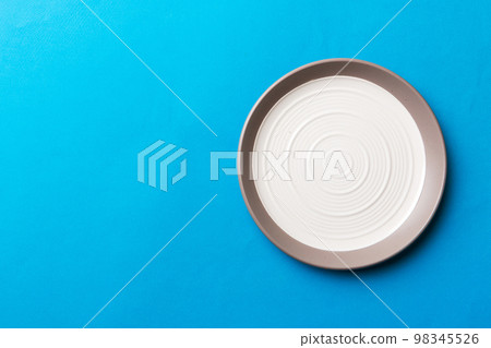 Top view of isolated of colored background empty round white plate for food. Empty dish with space for your design Top view of isolated of colored background empty round white plate for food. Empty dish with space for your design 98345526
