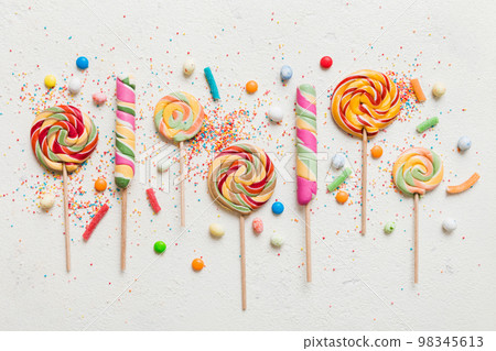 Tasty appetizing Party Accessories Happy Birthday Sweet. Different types of candies on colored background, copy space. Colorful birthday party background Tasty appetizing Party Accessories Happy Birthday Sweet. Different types of candies on colored background, copy space. Colorful birthday party background 98345613