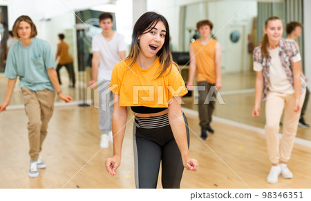 Group of teenagers rehearsing contemporary dance indoors Group of teenagers rehearsing contemporary dance indoors 98346351