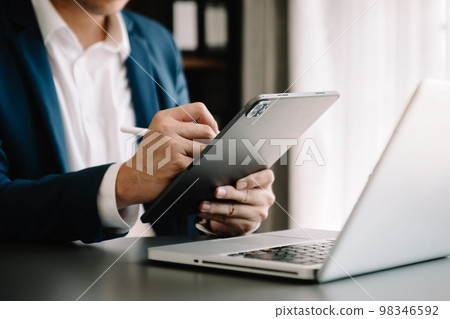 businessman hand using smart phone, tablet payments online shopping, omni channel, digital tablet docking keyboard computer at office . businessman hand using smart phone, tablet payments online shopping, omni channel, digital tablet docking keyboard computer at office . 98346592